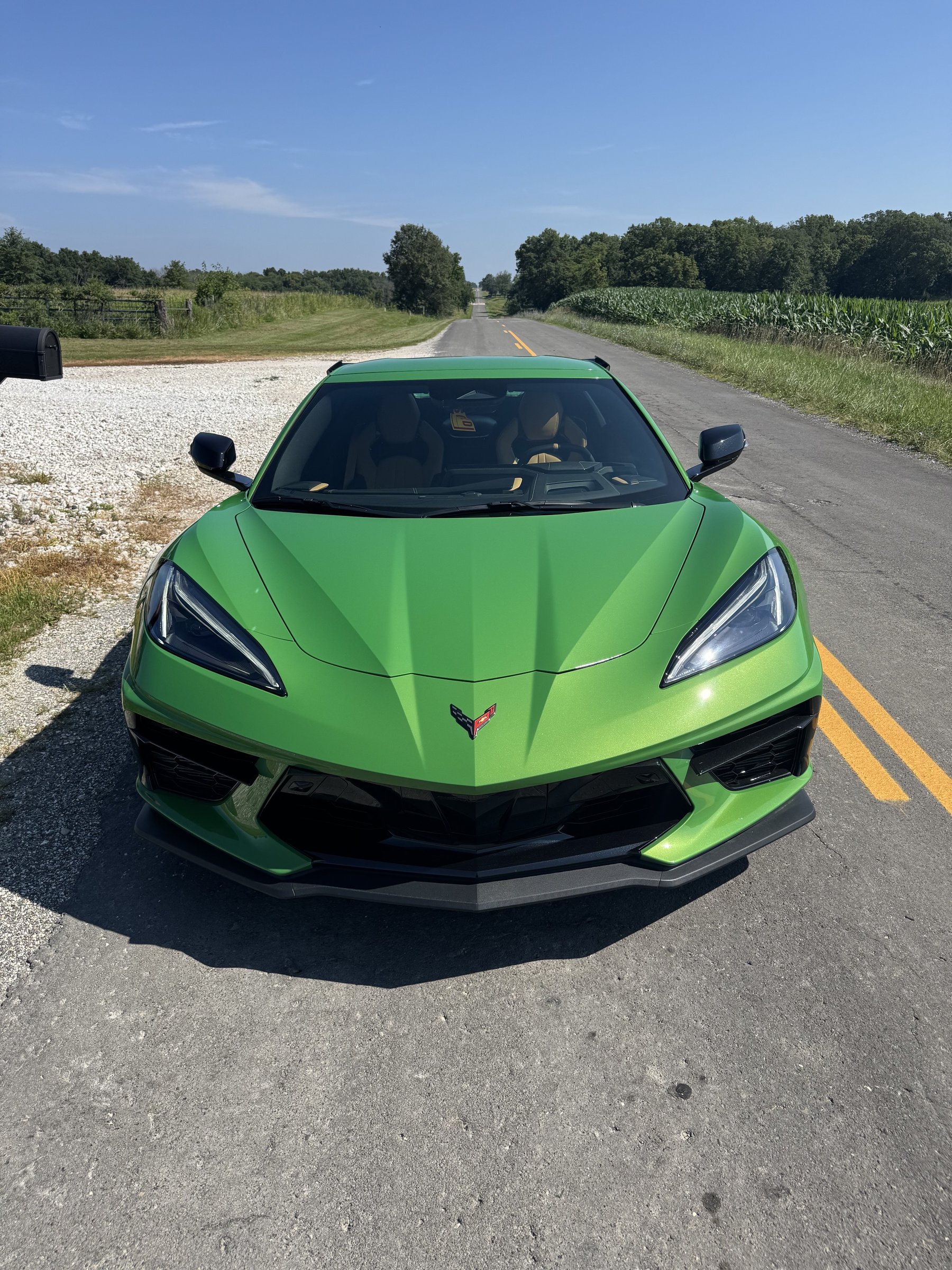 2026 Chevrolet Corvette C8 in Roswell Green, front view on a rural road